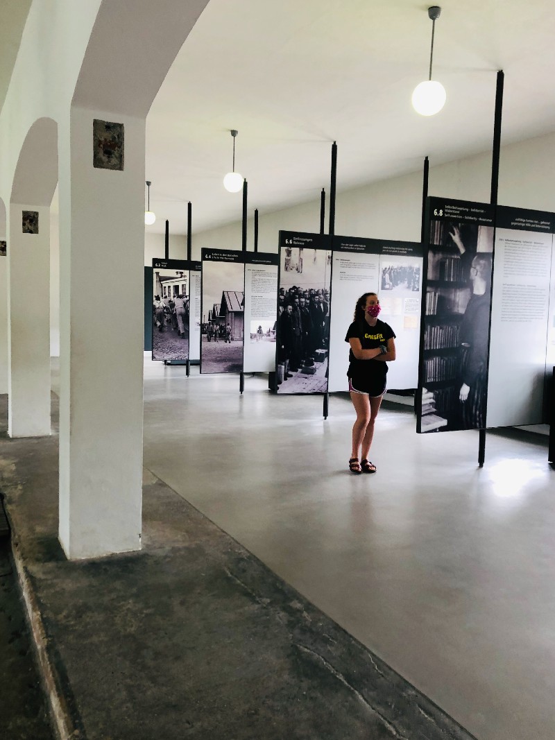 Teen tourist reading the exhibition at Dachau