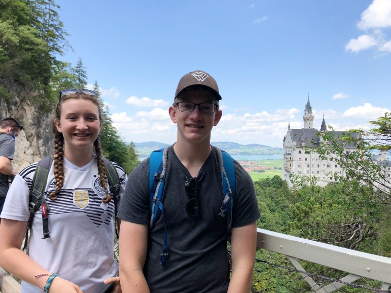 Teenagers standing on the bridge at Neuschwanstein. 