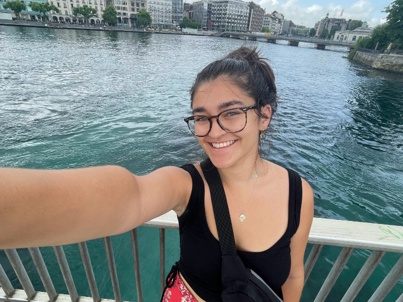 Teen girl taking a selfie in front of a river in Switzerland.